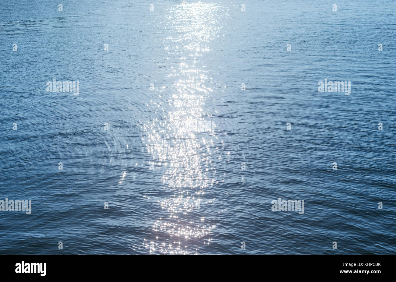 blue water surface with reflections of sun Stock Photo - Alamy