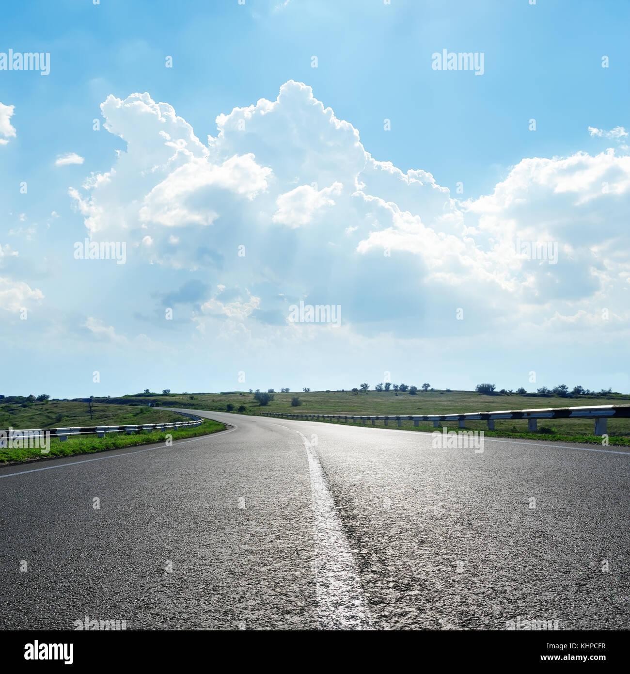 black asphalt road with white line under clouds in blue sky Stock Photo ...