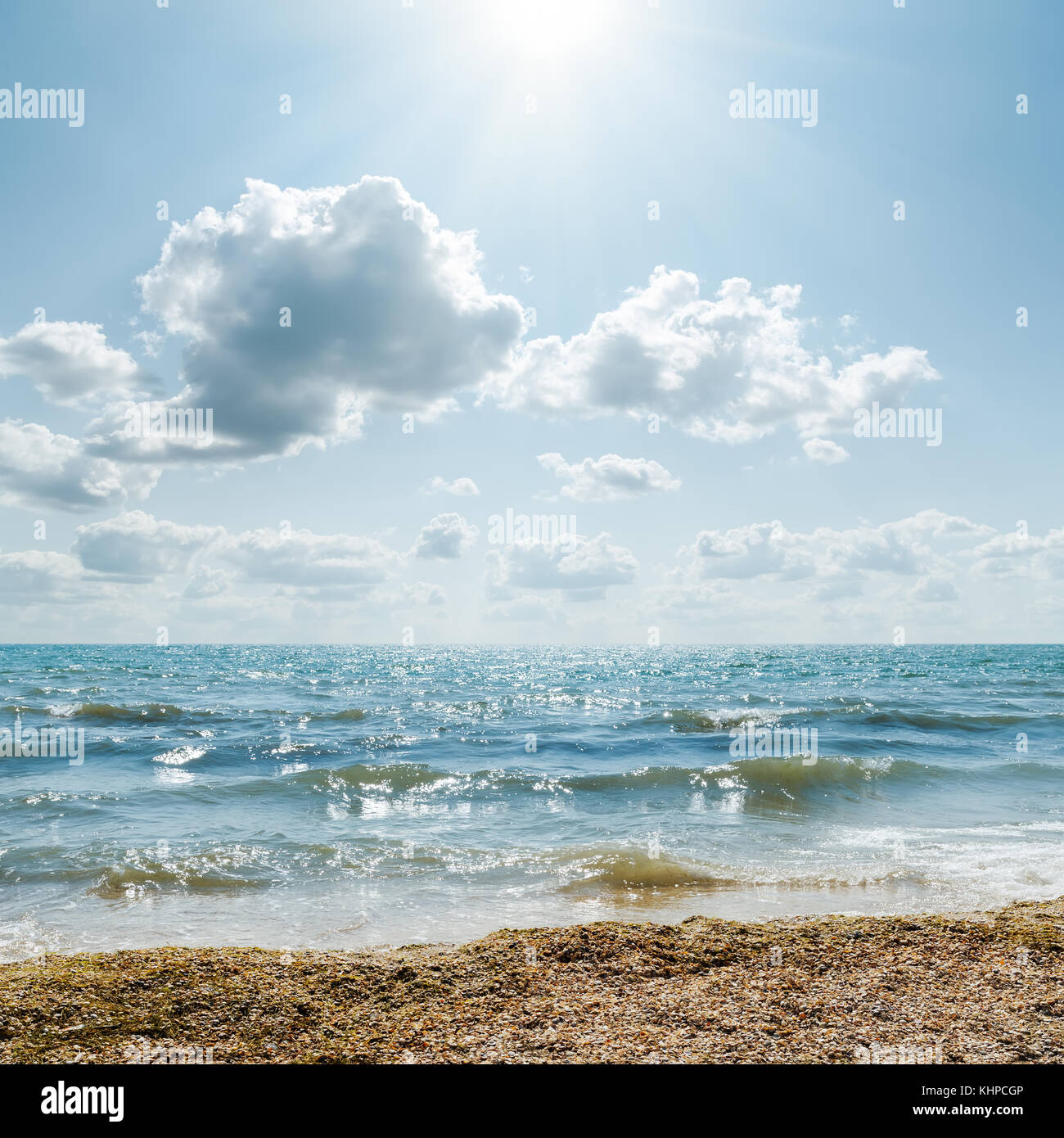 stormy sea and cloudy sky with sun Stock Photo - Alamy
