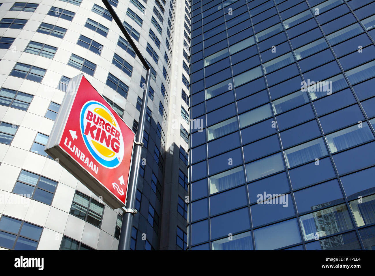 A fast food sign among high rise office blocks on Weena, Rotterdam city centre, The Netherlands. Stock Photo