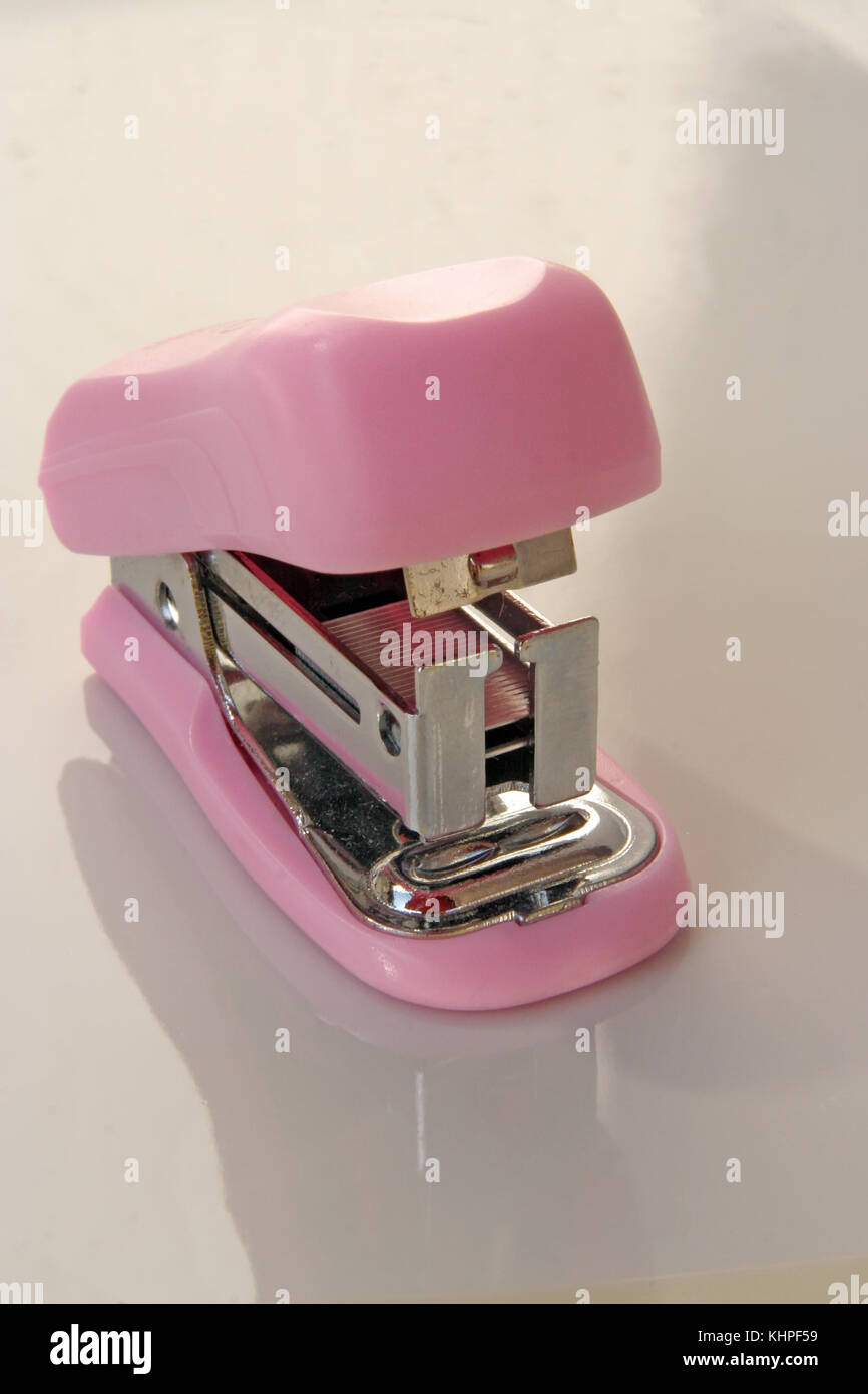 Pink stapler tool. Pink office tool. Stock Photo