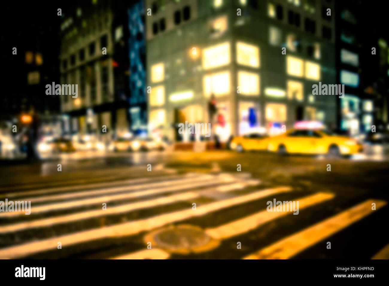 New York City street defocused night blur with taxi and buildings Stock Photo