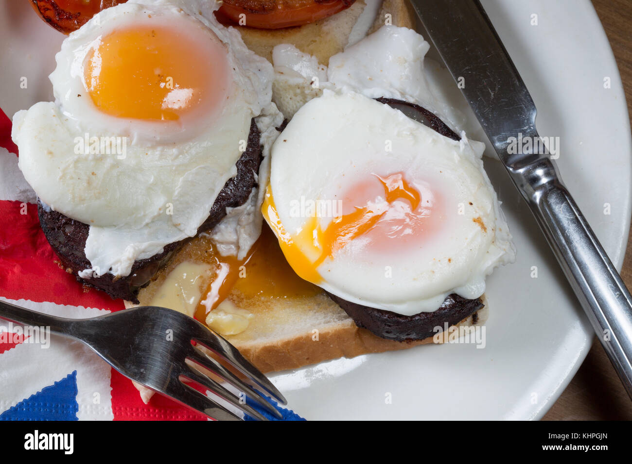 Simple English breakfast of Poached egg and Back pudding on toast with