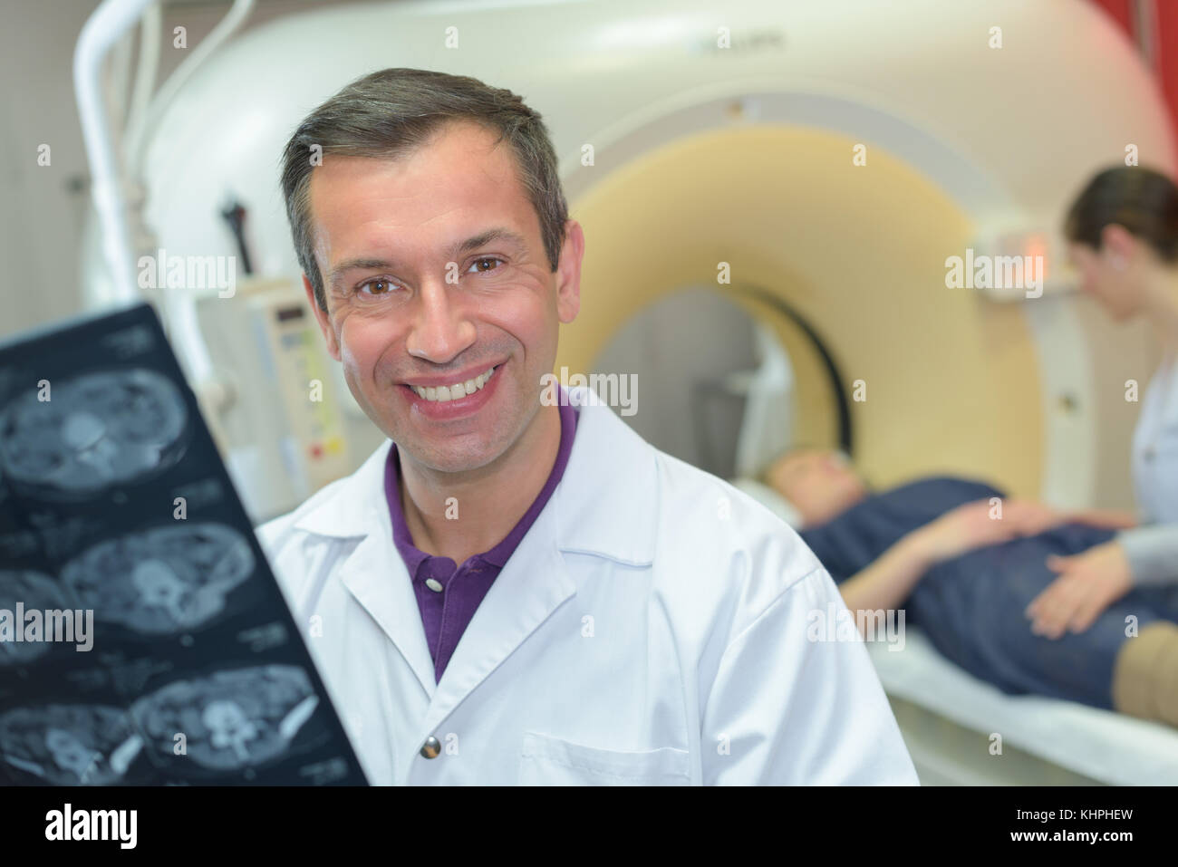 male doctor examining woman ct scanner Stock Photo