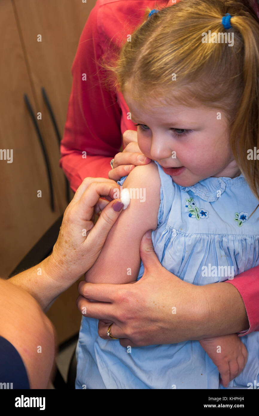 Practice nurse giving NHS 4in1 preschool booster / Pre school