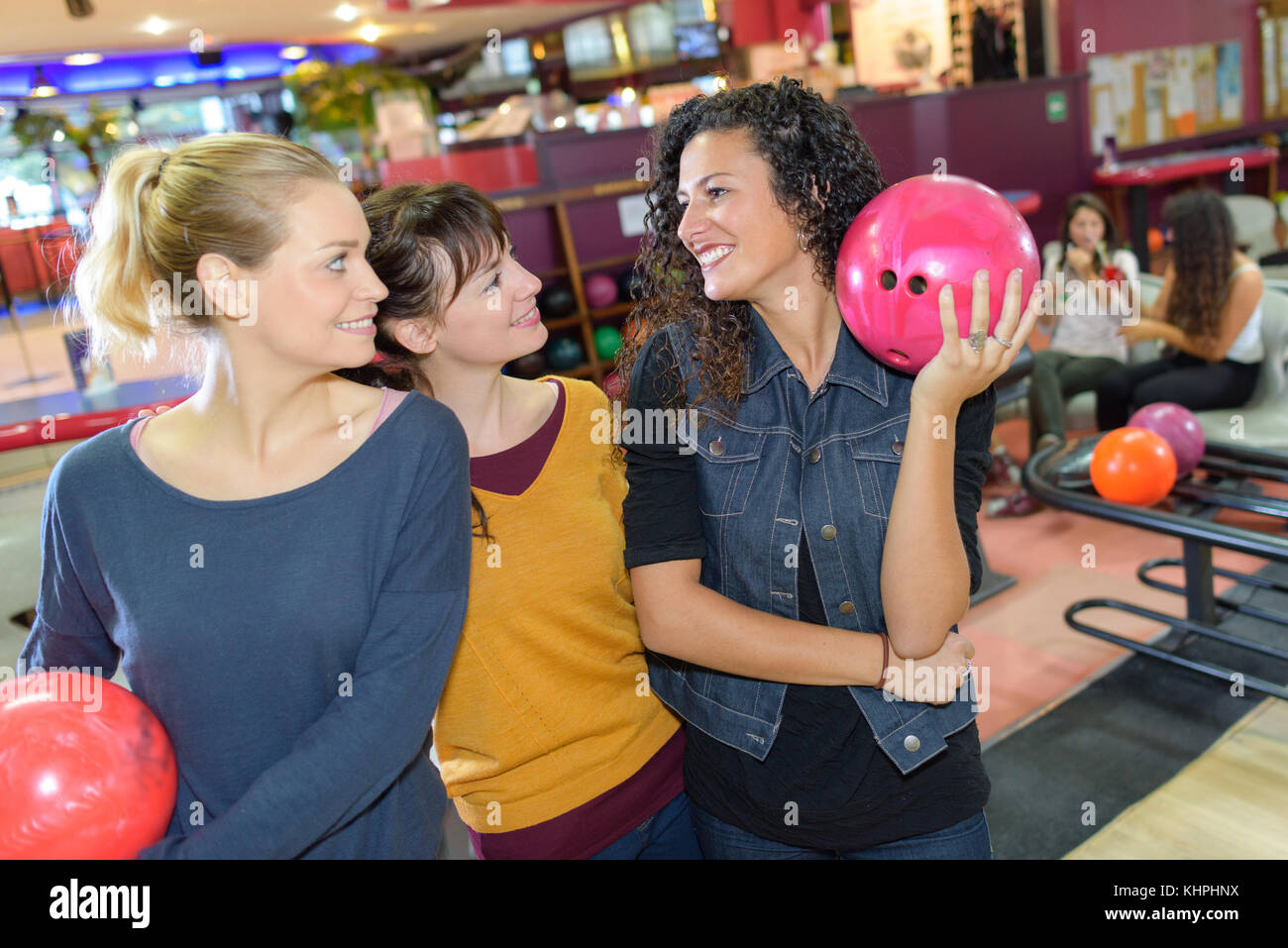 friends holding bowling balls Stock Photo Alamy
