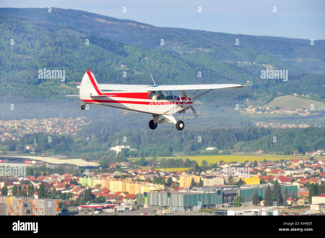 Airplane fly over city, light aircraft, single engine Stock Photo
