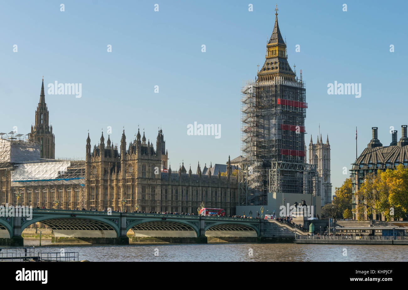 LONDON, UK - October 17th, 2017: Westminster bridge and big ben renovation construction with the house of parliament in view, sunny day, clear sky. Stock Photo