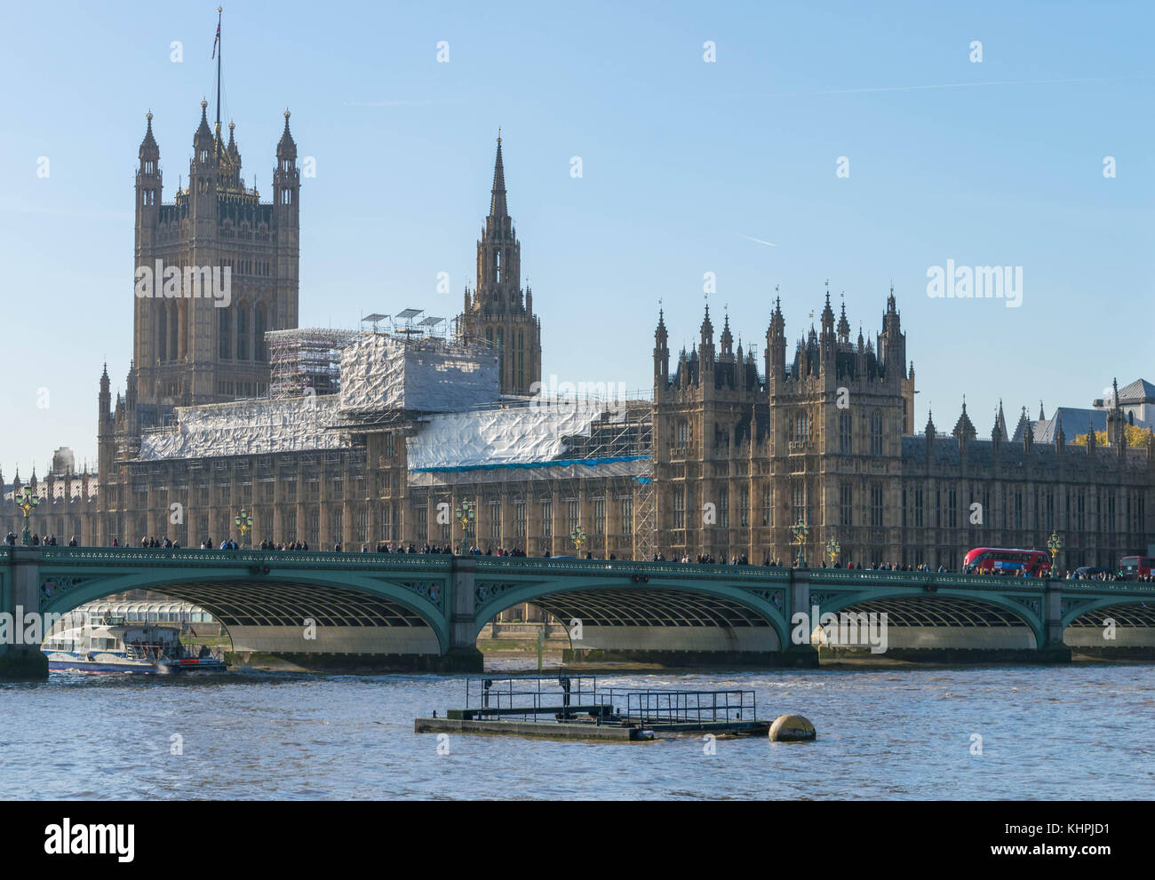 LONDON, UK - October 17th, 2017: Westminster bridge and big ben repain construction with the house of parliament in view, sunny day, clear sky. Stock Photo