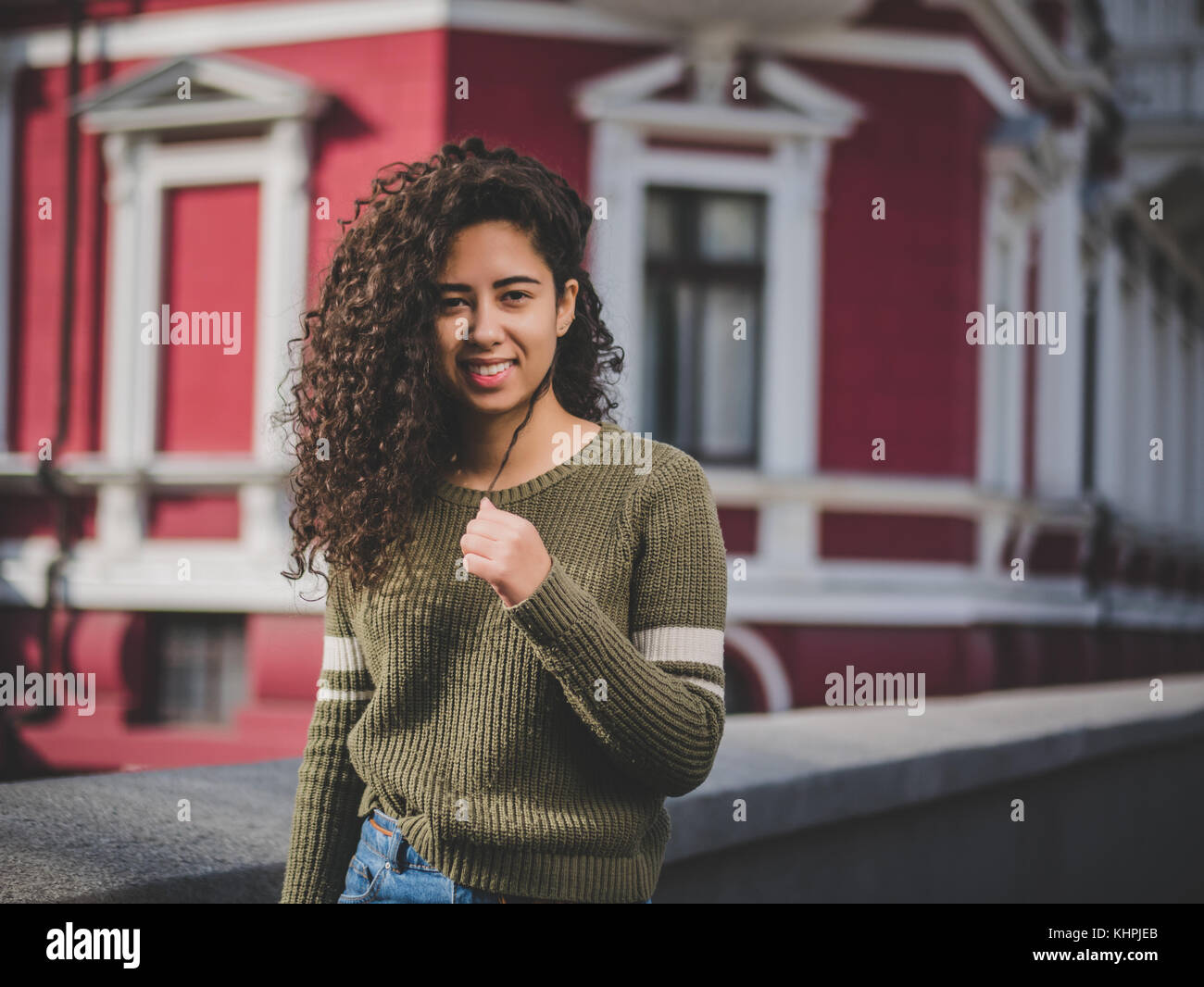 Portrait Of Happy Young Hispanic Woman With Beautiful Curly Hair
