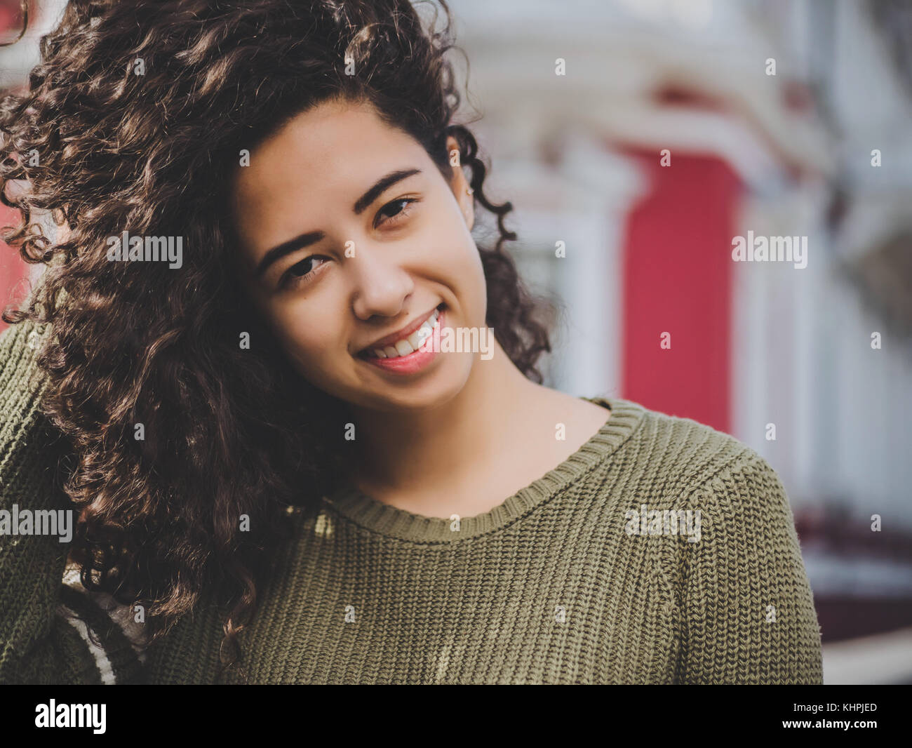 Portrait Of Happy Young Hispanic Woman With Beautiful Curly Hair
