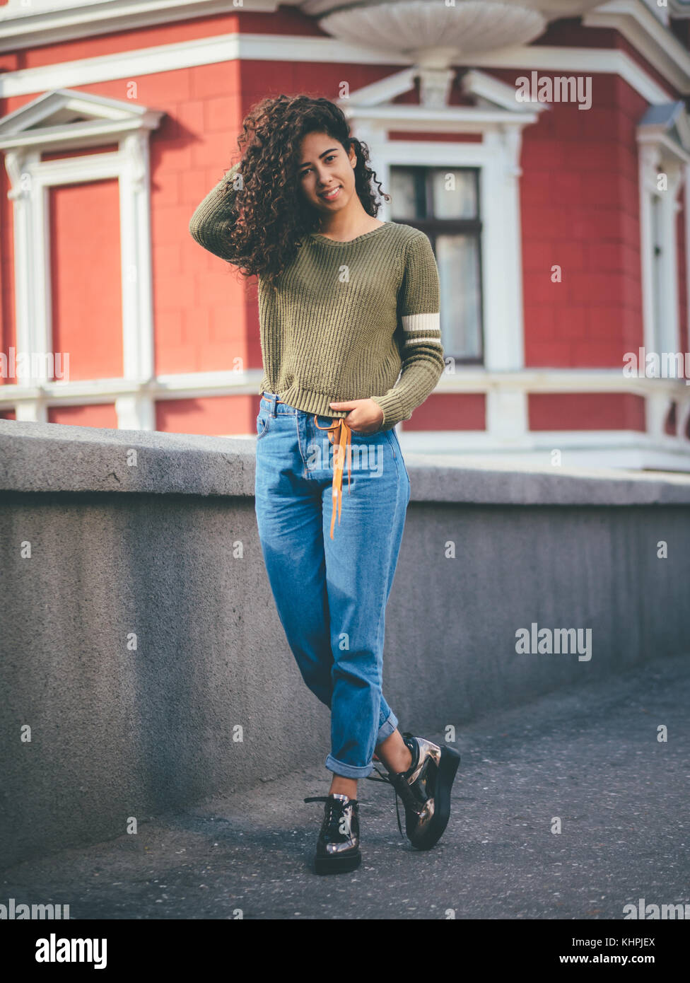 Portrait Of Happy Young Hispanic Woman With Beautiful Curly Hair