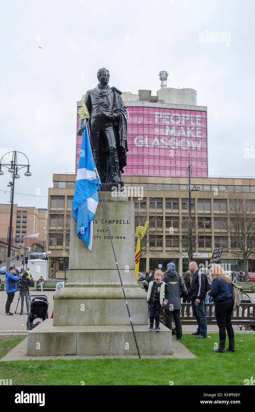 GLASGOW, SCOTLAND- APRIL 04 2015: A saltire leaning on the statue of Scots poet Thomas Campbell. Stock Photo