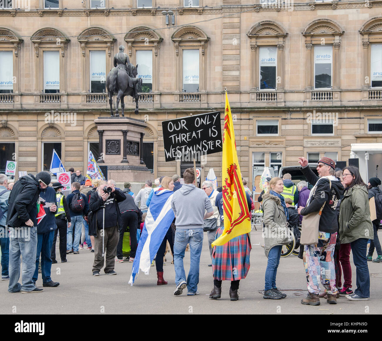 GLASGOW, SCOTLAND- APRIL 04 2015: A man holding an 'Our only threat is Westminster' banner at a Bairns Not Bombs Scrap Trident Demo at George Square Stock Photo