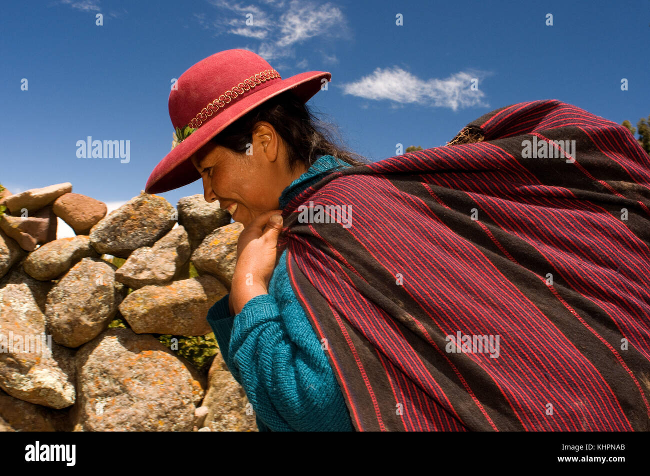 A woman heads home after a hard day in the countryside on the island of Amantani. Amantani Island, Lake Titicaca, Puno, Peru Stock Photo