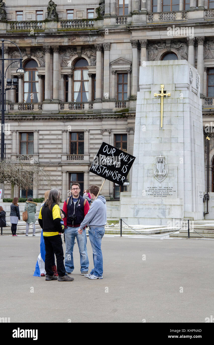 GLASGOW, SCOTLAND- APRIL 04 2015:  A group of people with an anti-Trident banner standing near the First World War Cenotaph. Stock Photo