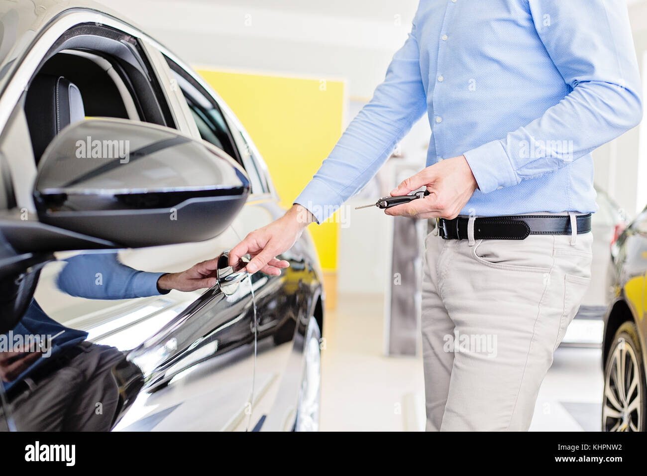 Close up photo of male adult person holding a car keys in one hand