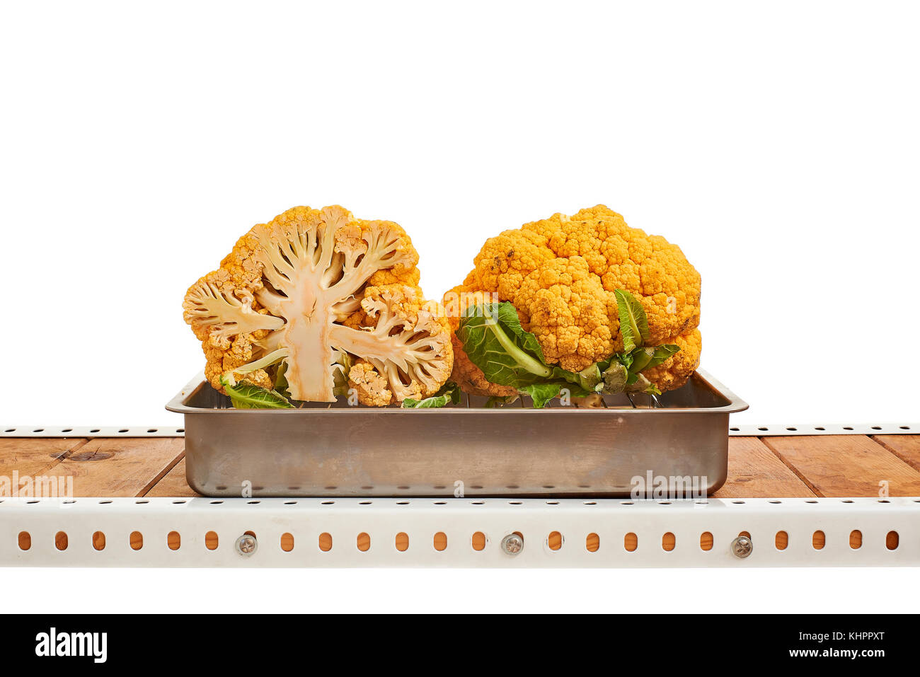 Raw yellow cauliflower in a metallic oven tray isolated on white. Stock Photo