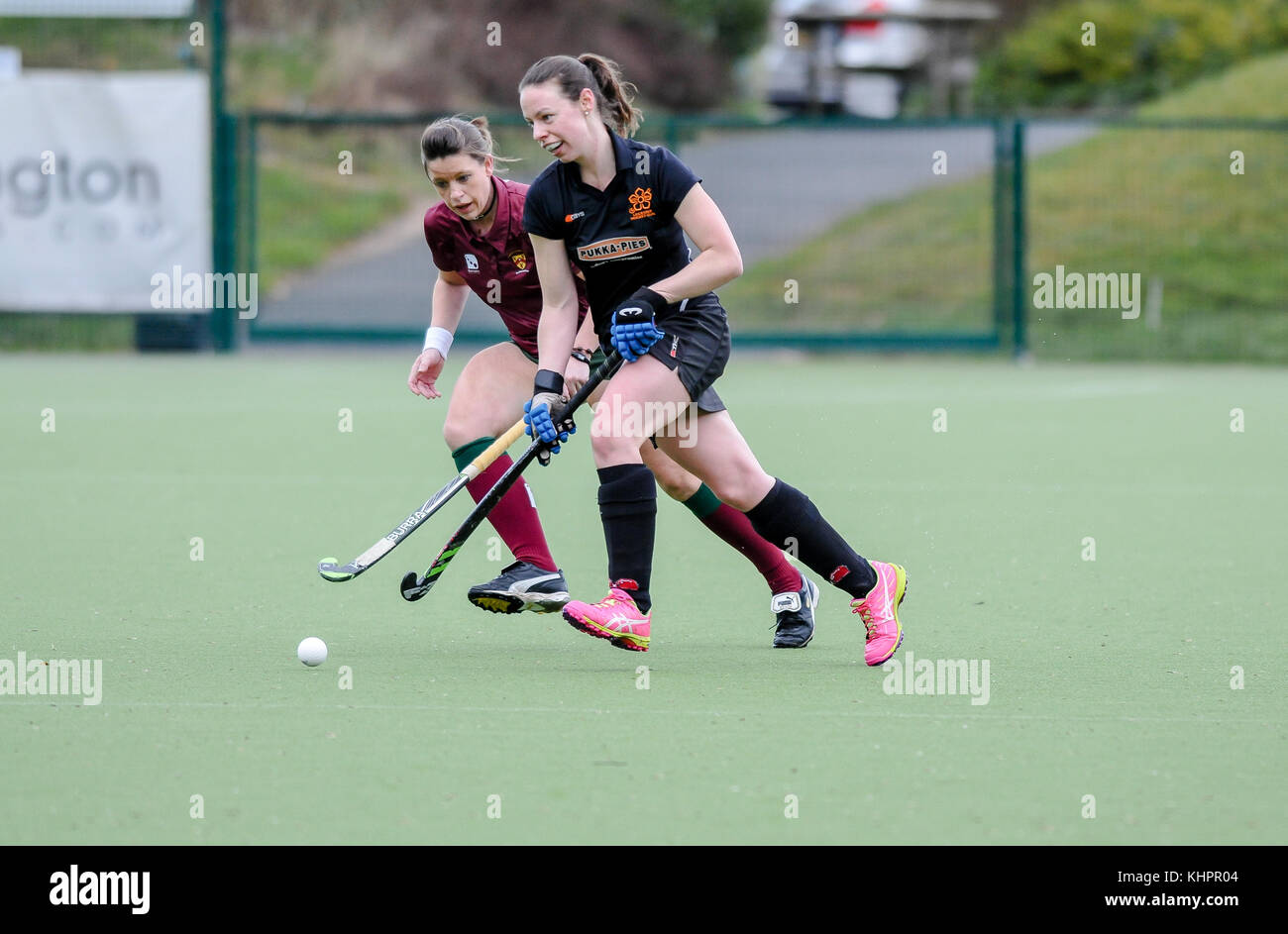 Two female field hockey players competing for the ball Stock Photo