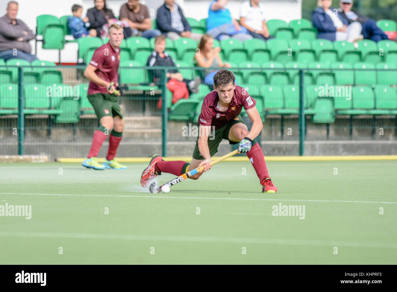 Mens field hockey, England, UK. Player hitting the ball Stock Photo Alamy