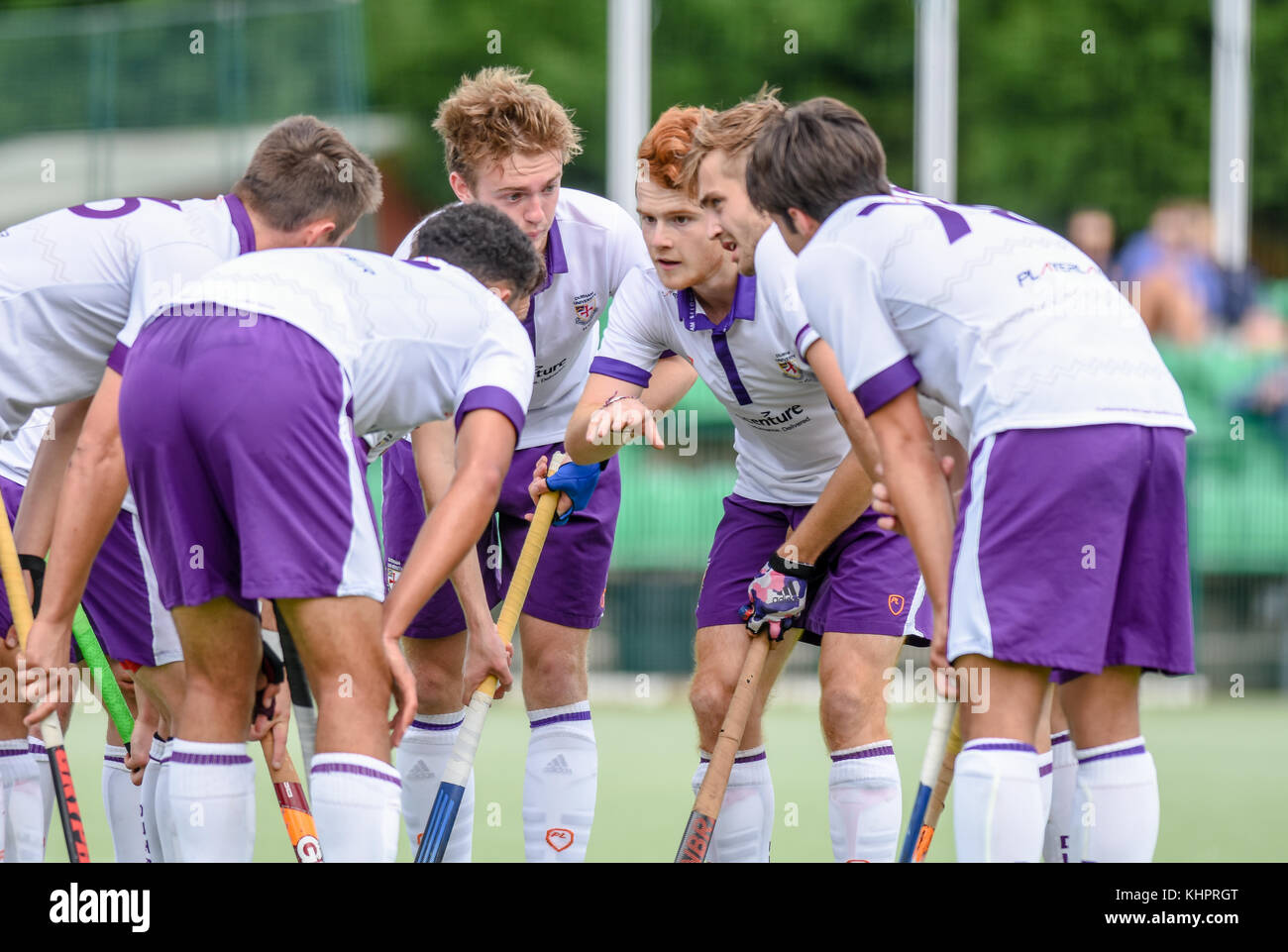 Mens field hockey team before starting a game huddled together Stock