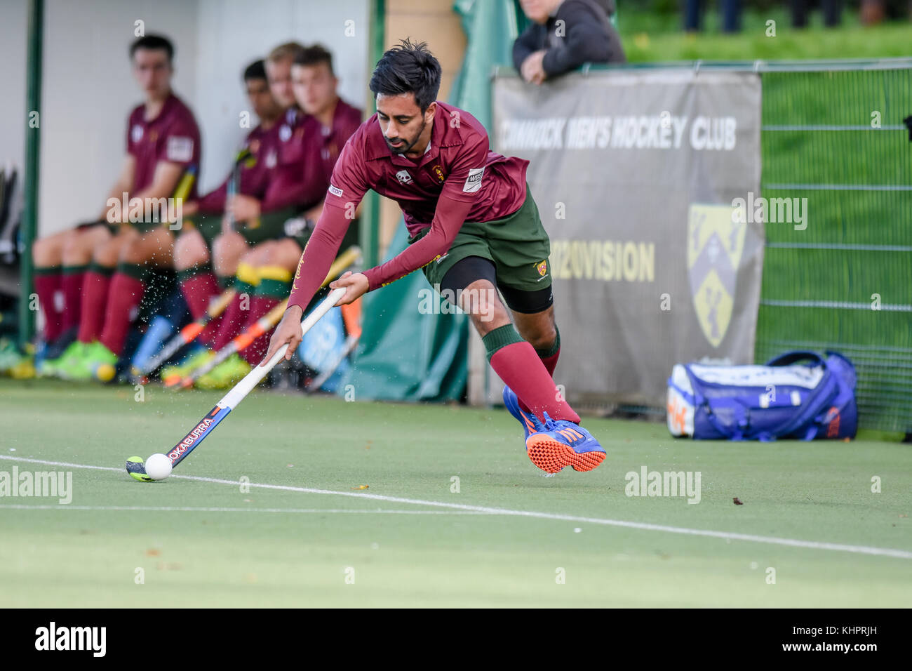 Mens field hockey, England, UK. Player running with the ball Stock