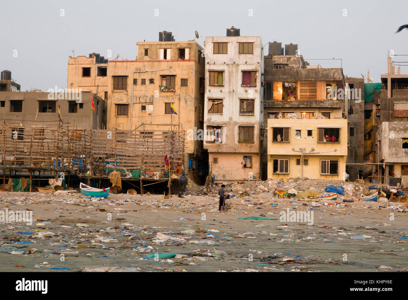 Seafront apartment building at plastic garbage covered Versova beach