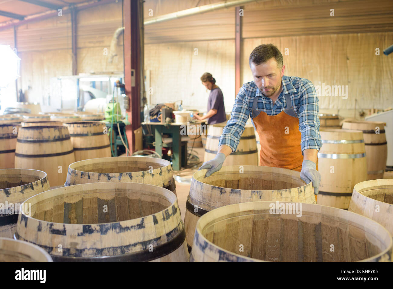 wood barrels production cooper using hammer and tools in workshop Stock ...