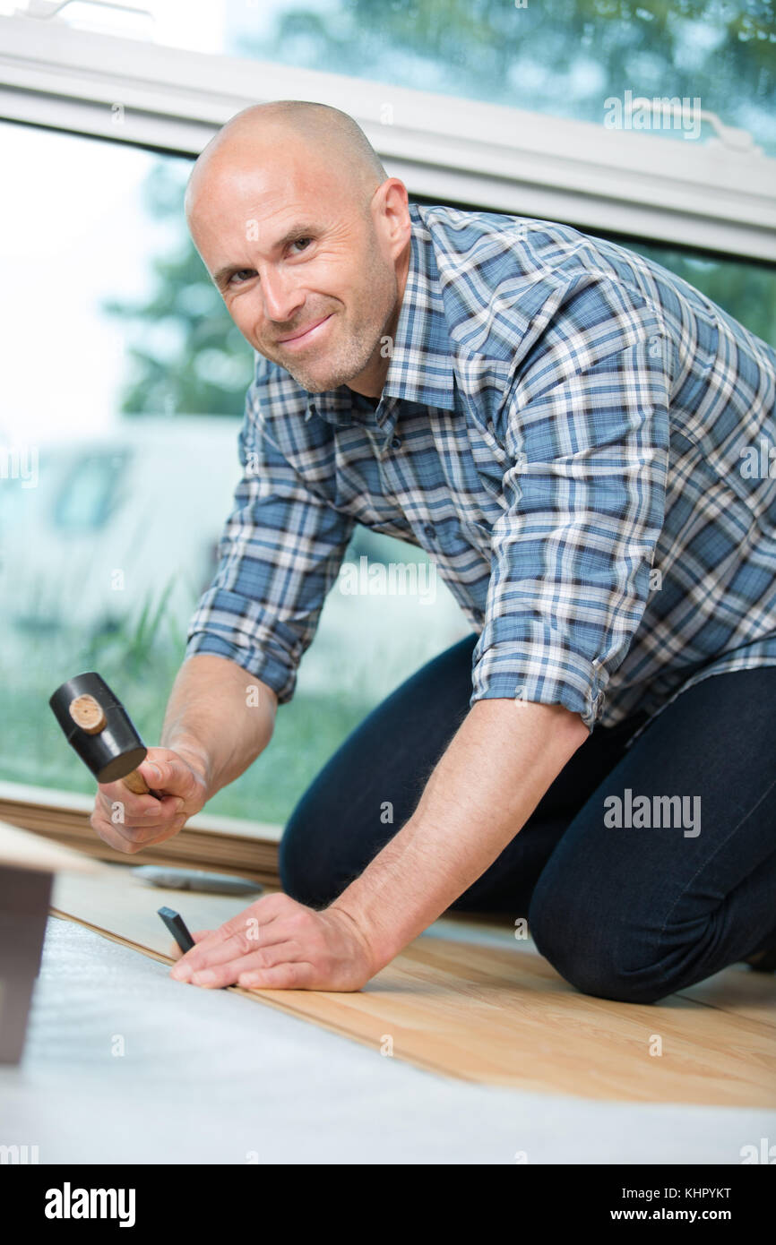 man installing the flooring Stock Photo Alamy