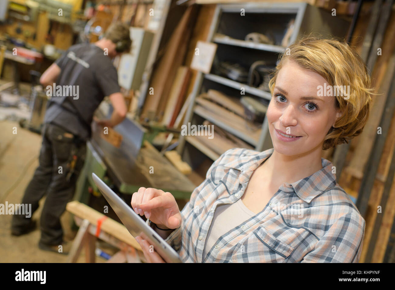 female supervisor holding digital tablet in workshop Stock Photo