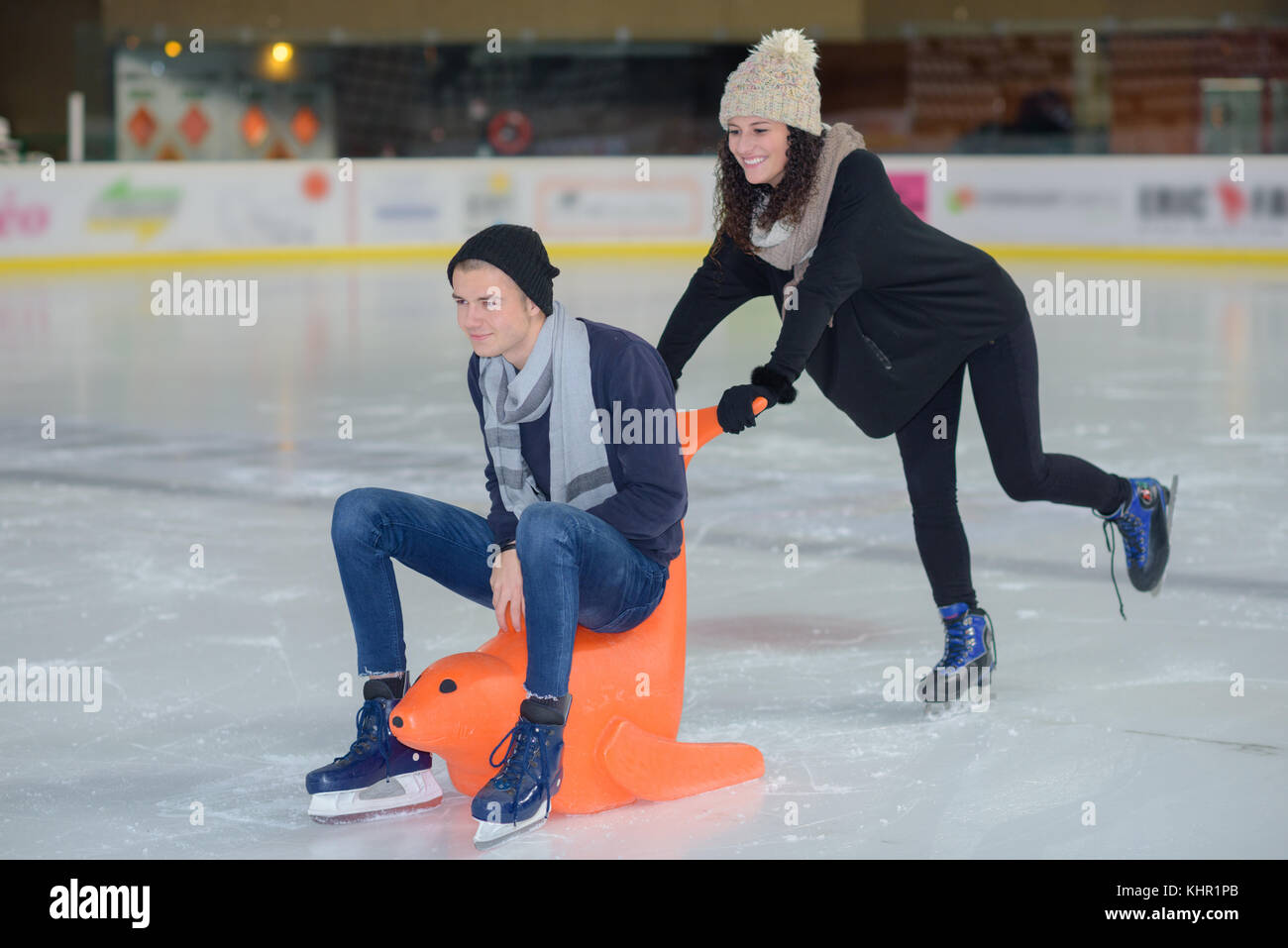 young couple skating together at ice rink Stock Photo - Alamy