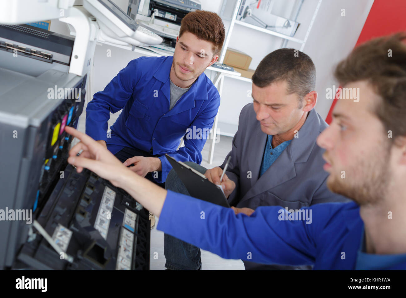 group of apprentice mending a printer Stock Photo - Alamy