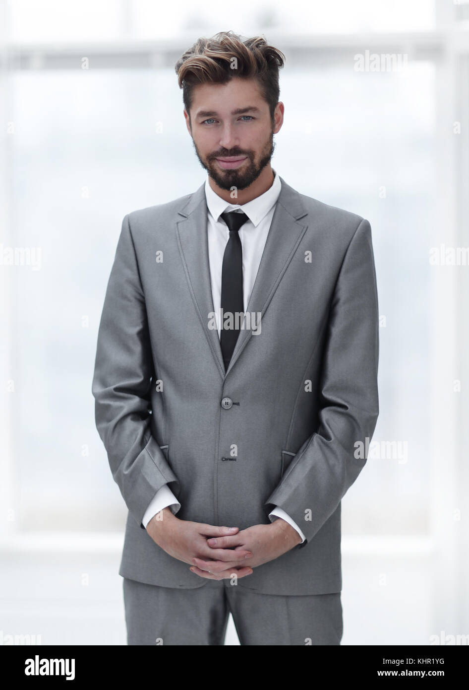 A young man in a gray suit Stock Photo - Alamy