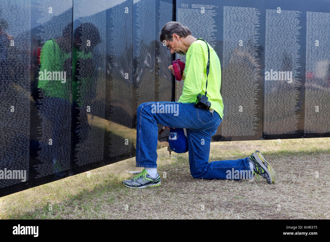 Family member remembering a Vietnam War Veteran,, Vietnam Memorial Traveling Wall. Stock Photo