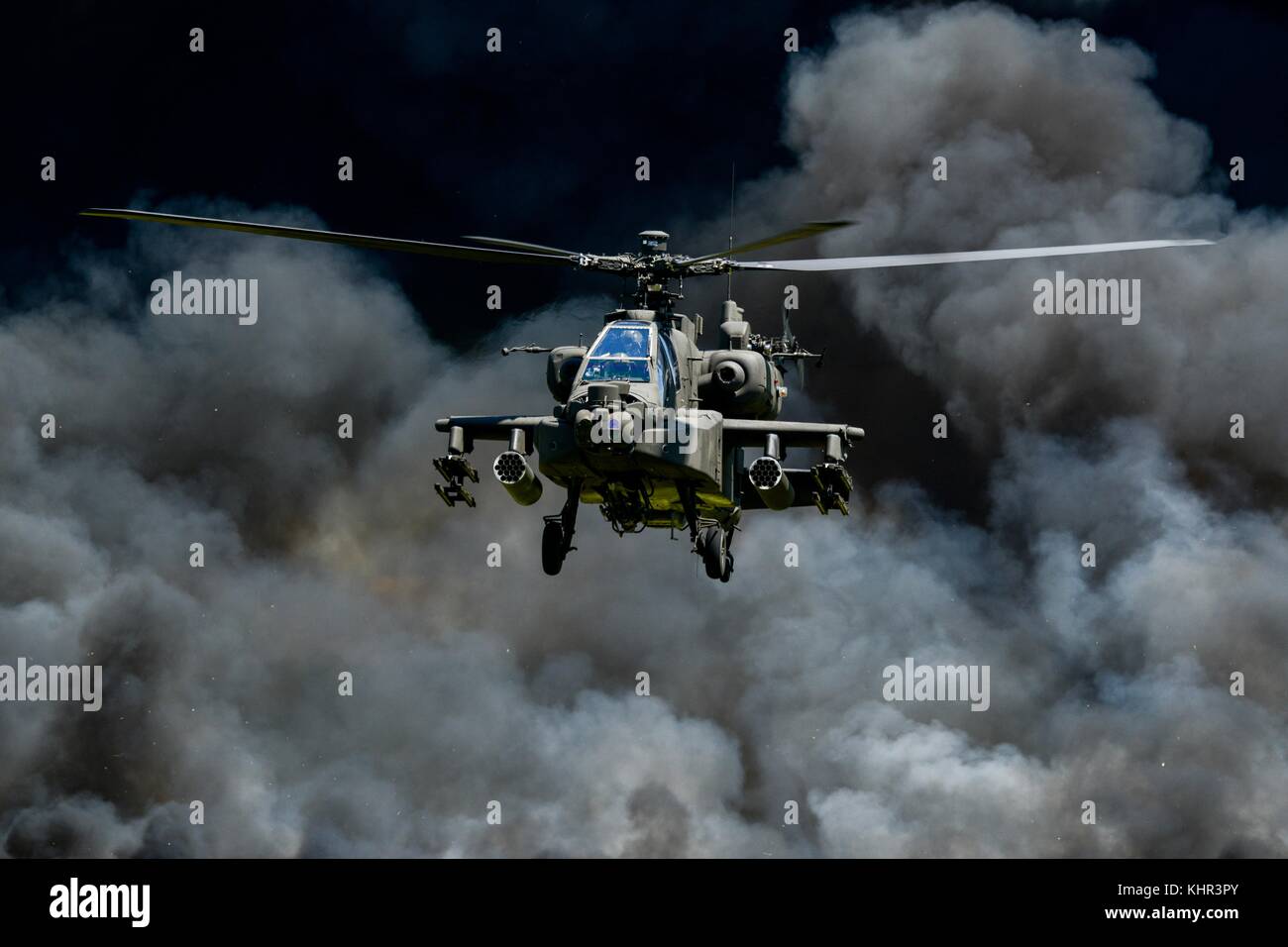 A U.S. Army AH-64D Apache attack helicopter flies in front of a wall of fire and smoke during the South Carolina National Guard Air and Ground Expo at the McEntire Joint National Guard Base May 6, 2017 in Hopkins, South Carolina.  (photo by Jorge Intriago via Planetpix) Stock Photo