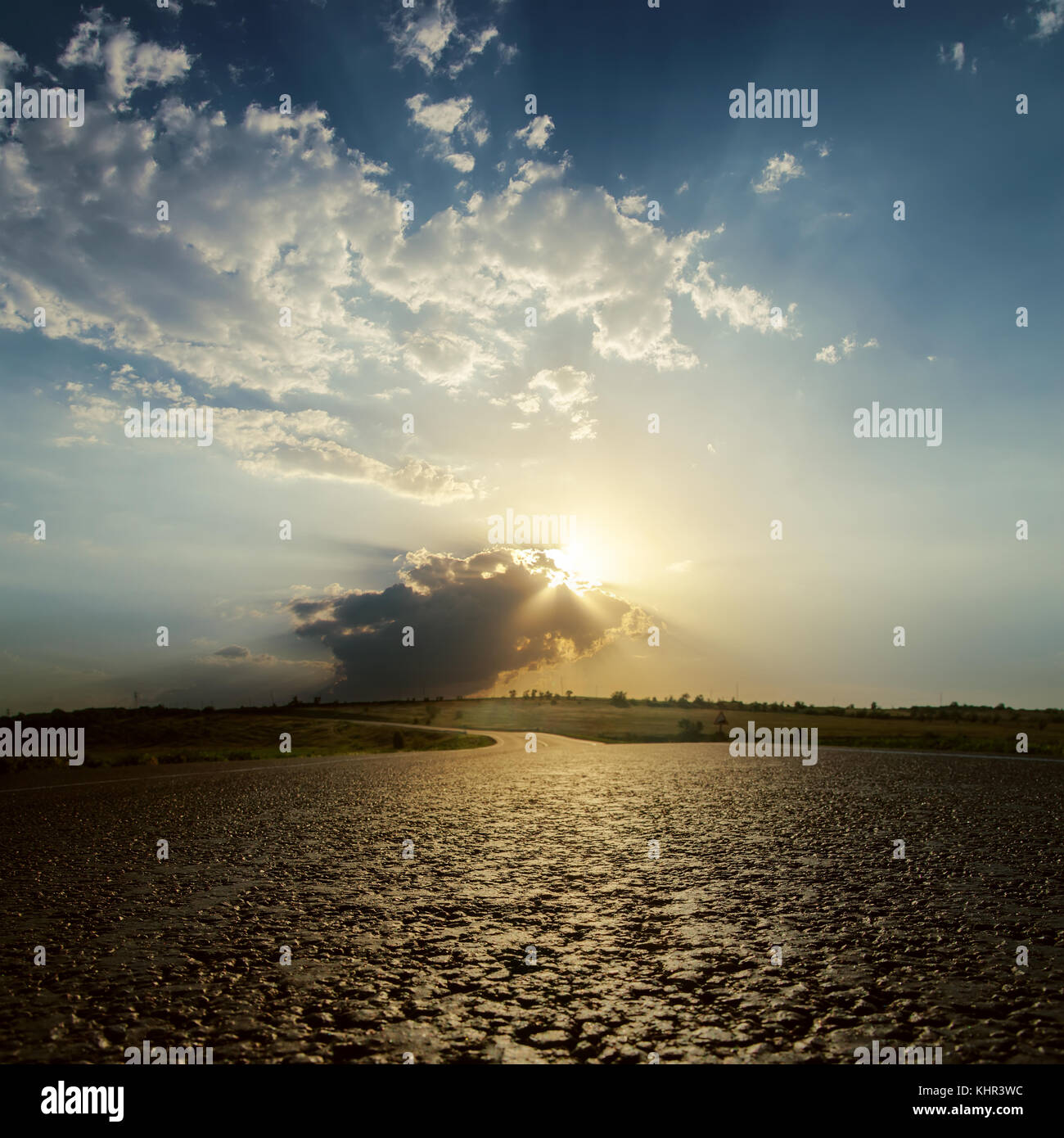 low sun in clouds on sunset over asphalt road. soft focus Stock Photo ...
