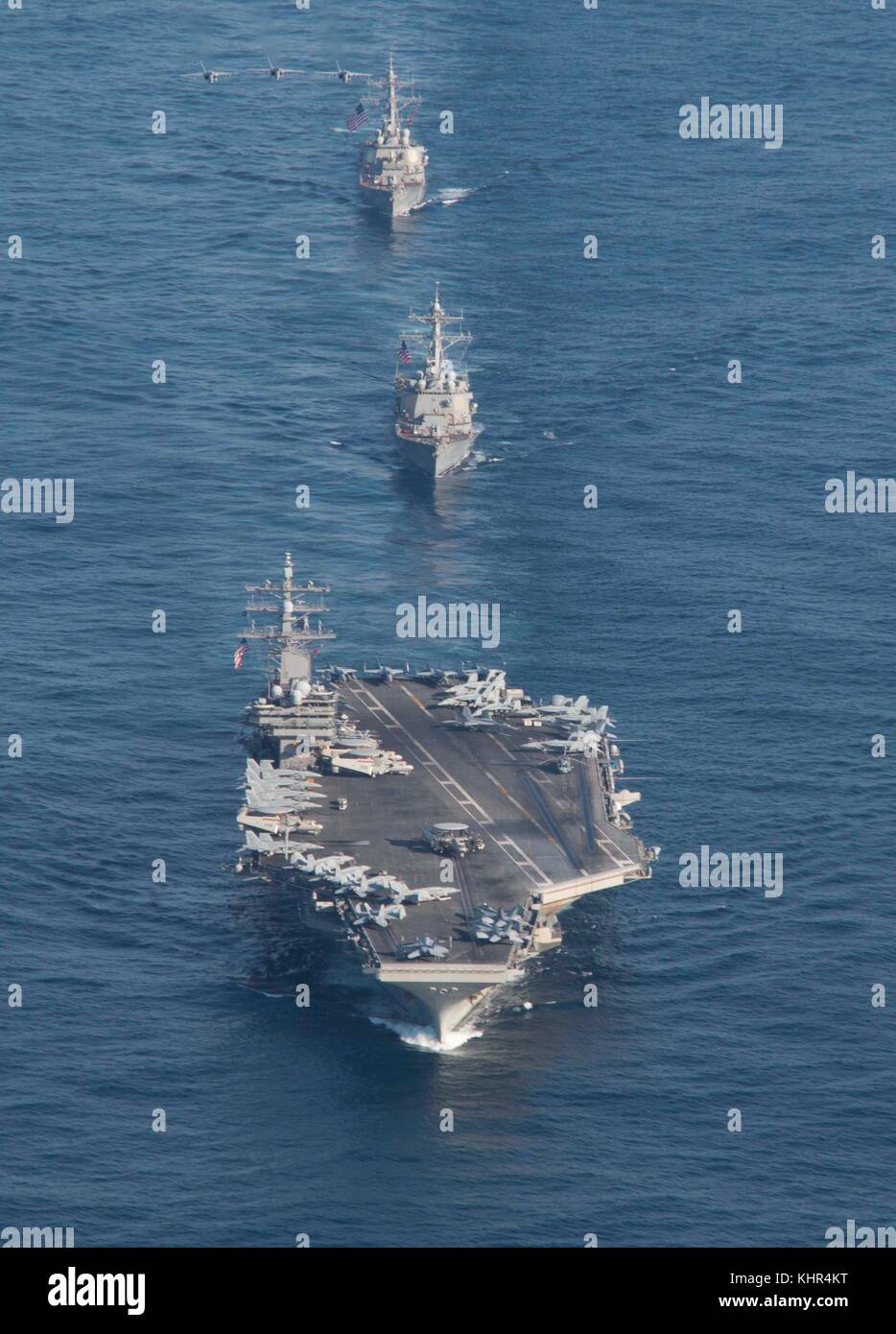 The U.S. Navy Nimitz-class aircraft carrier USS Ronald Reagan (front) leads U.S. ships in formation November 12, 2017 in the Pacific Ocean.  (photo by James Griffin via Planetpix) Stock Photo