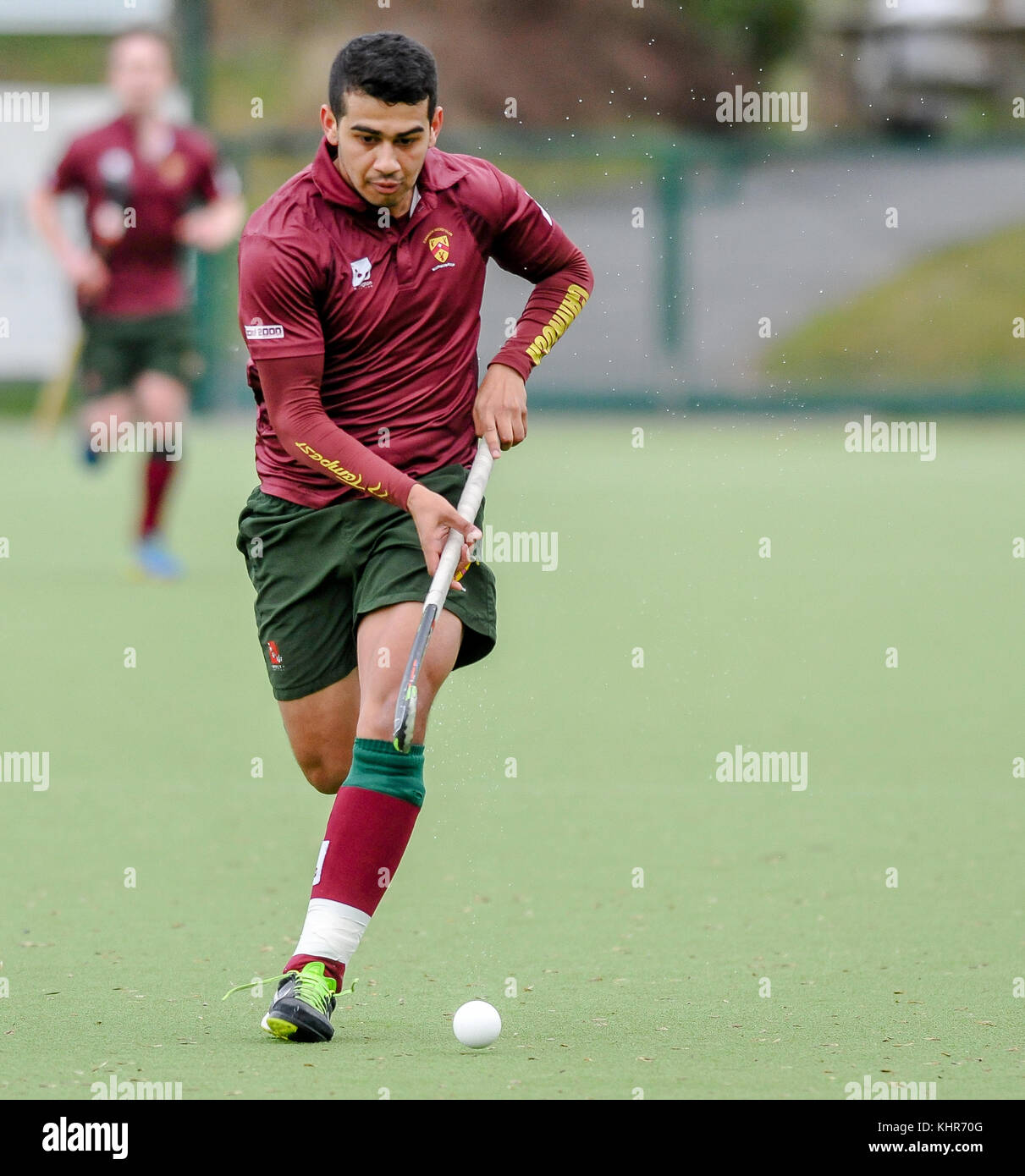 Mens field hockey, England, UK. Player running with the ball Stock