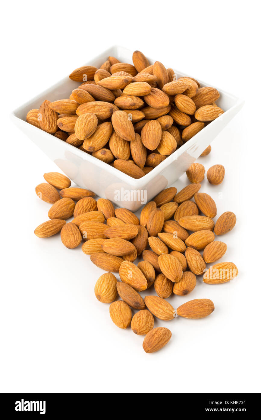 Heap of shelled almond kernels in white bowl over white background Stock Photo Alamy
