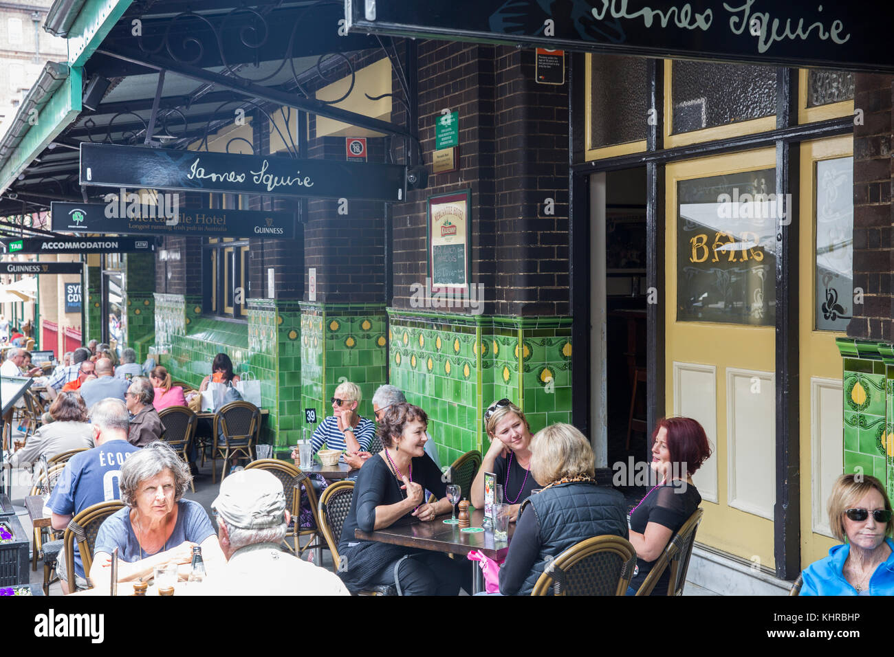 People sitting outside at the Mercantile pub hotel in The Rocks Sydney enjoying an afternoon drink and a beer,Sydney,Australia Stock Photo