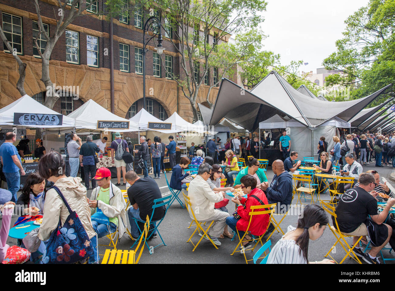 People sitting enjoying food at the outdoor saturday markets in The Rocks heritage area of Sydney,Australia Stock Photo