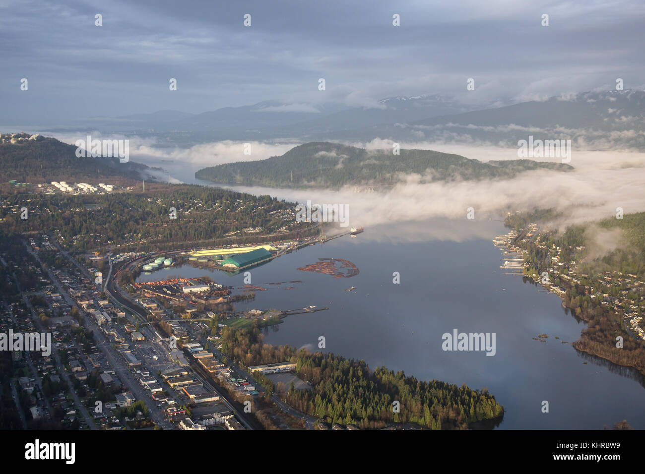Aerial View of Port Moody, Greater Vancouver, British Columbia, Canada. Taken during a cloudy sunrise with fog patches. Stock Photo