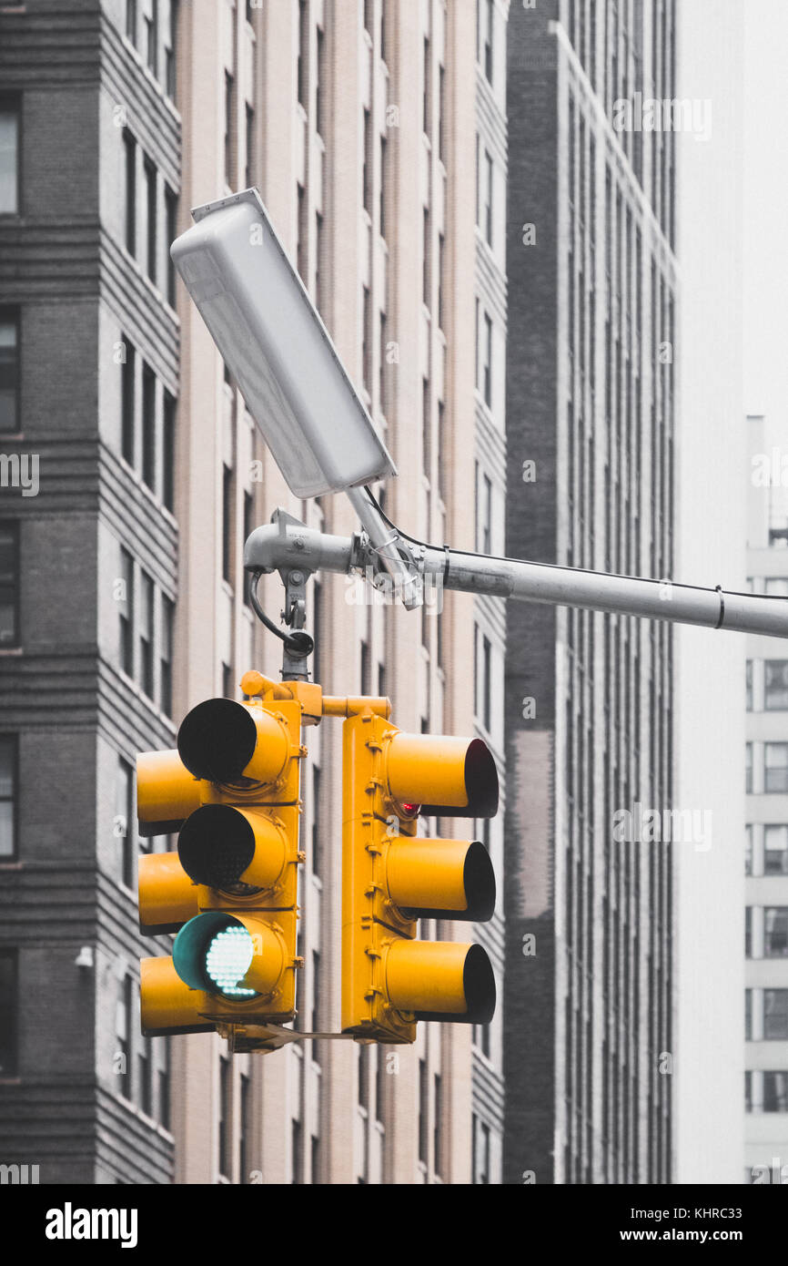 Over-hanging yellow traffic lights around Times Square in New York City. Stock Photo