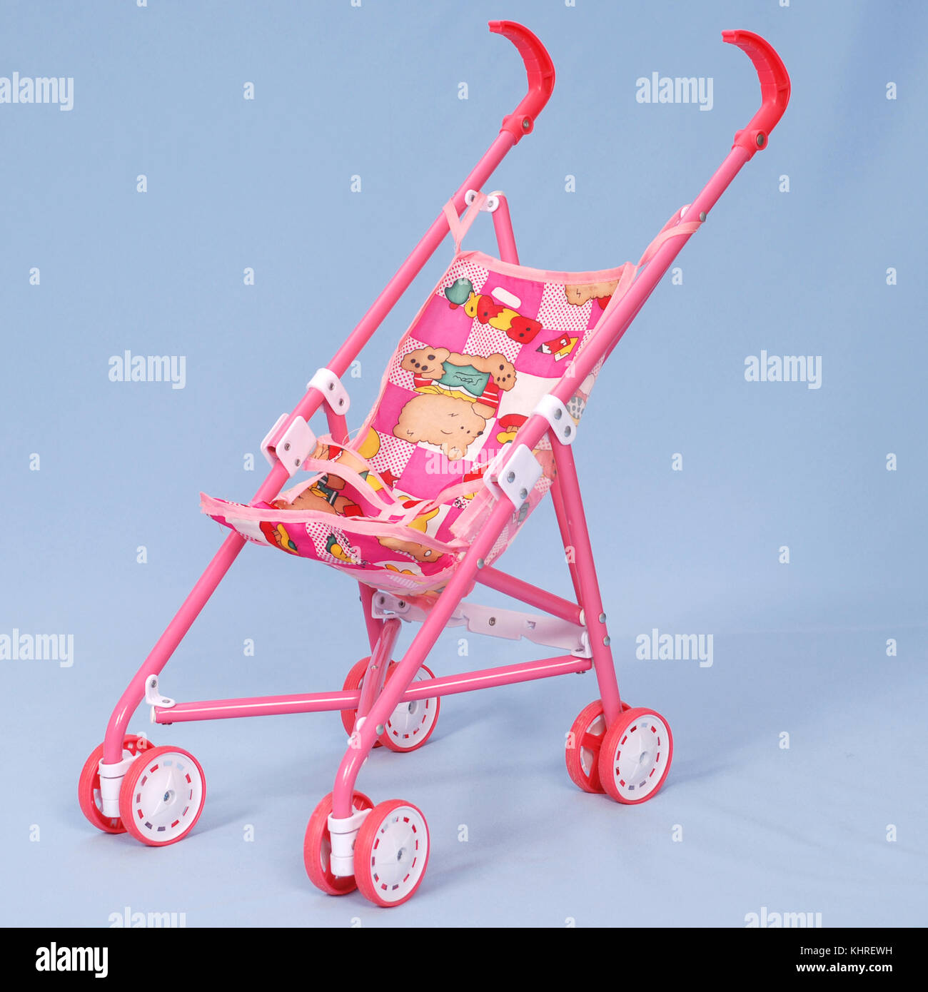 Toy baby buggy on blue background Stock Photo Alamy