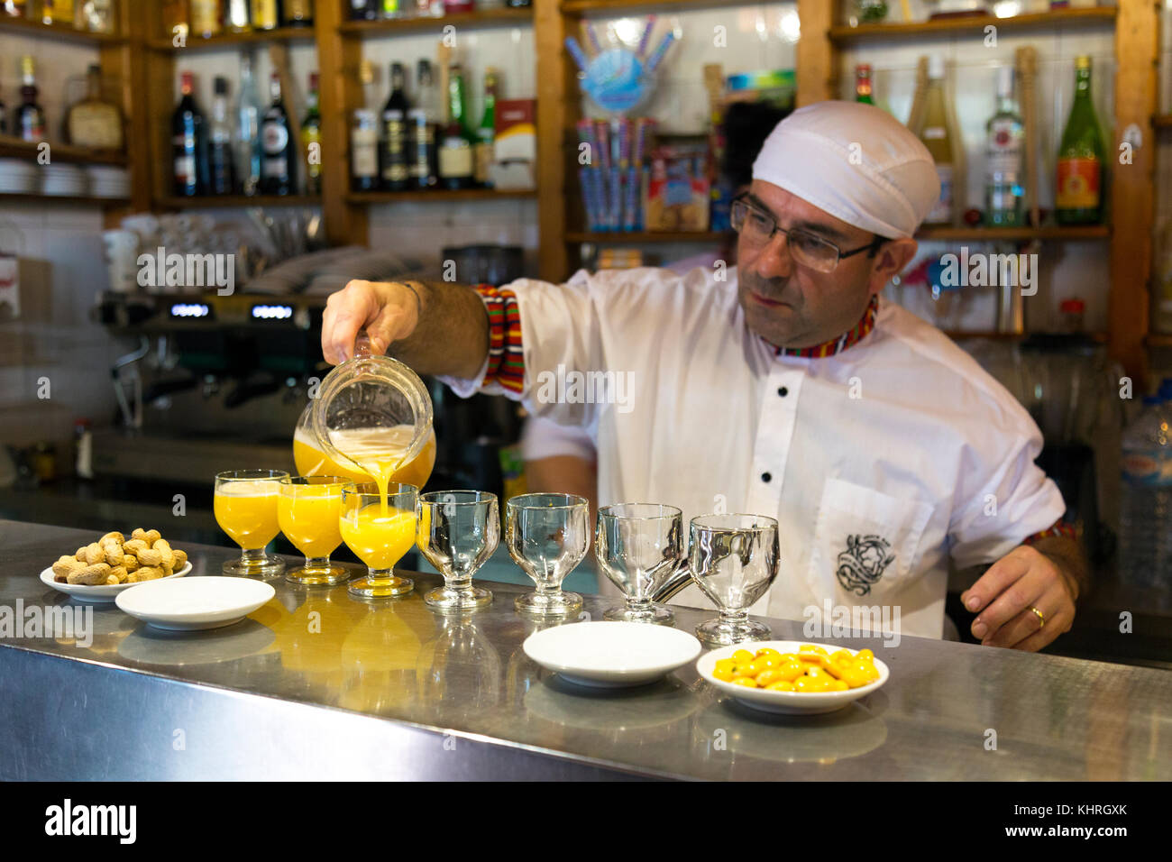 Bartender preparing poncha - traditional Madeiran alcoholic drink, Snack Bar Encumeada, Madeira, Portugal Stock Photo