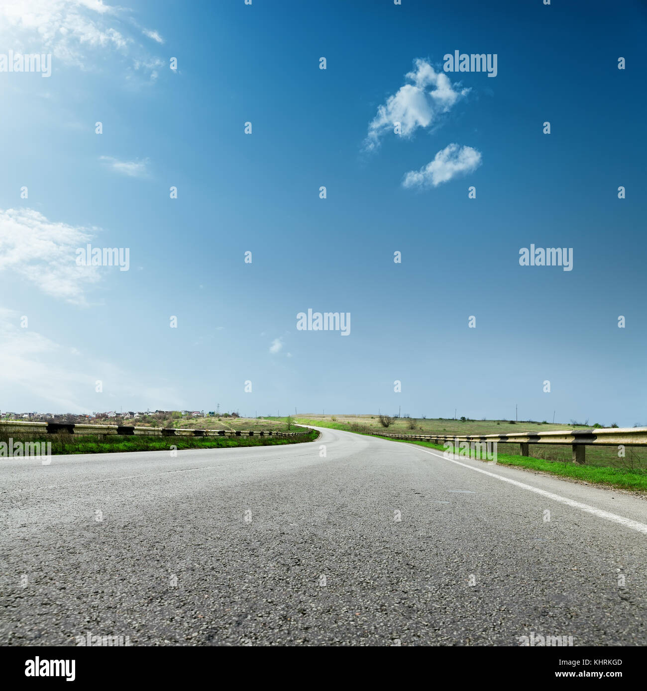 asphalt road to horizon closeup and blue sky with clouds Stock Photo ...