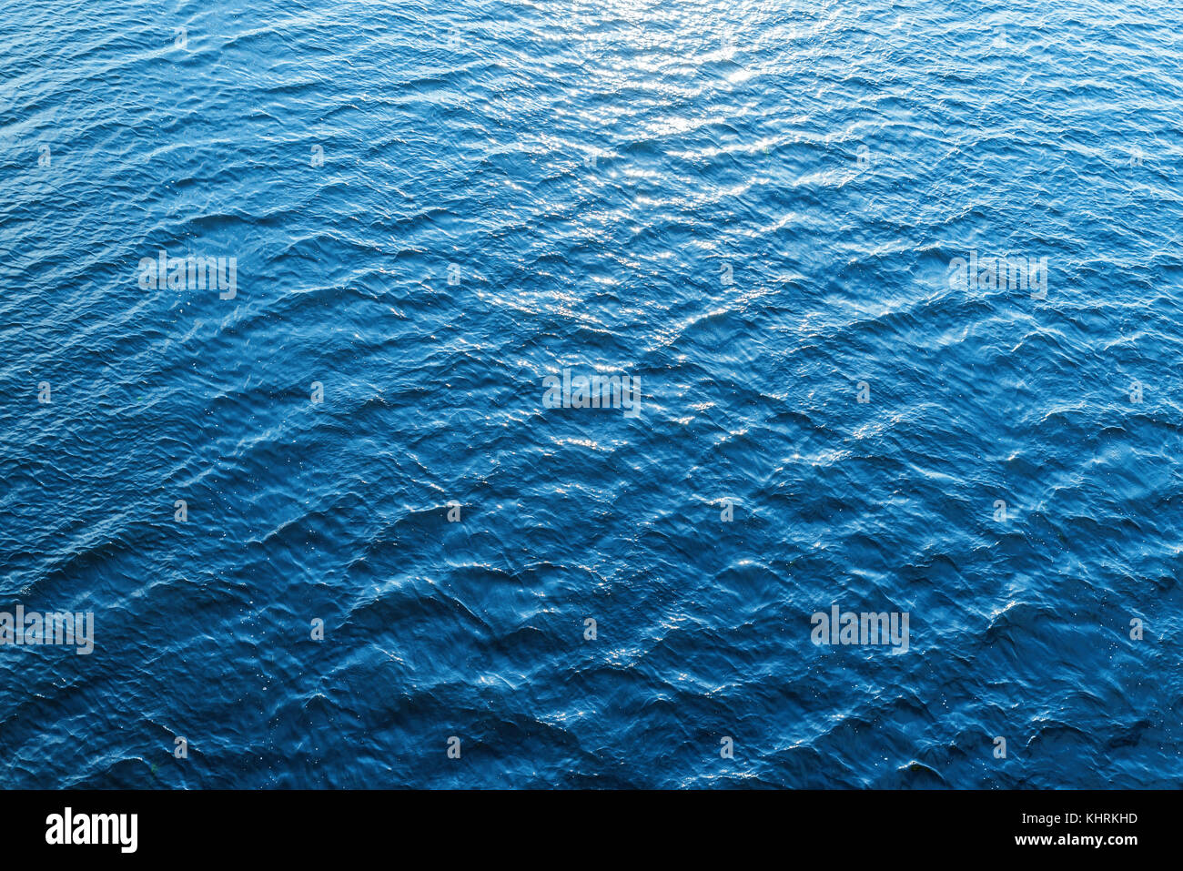 blue water as background with sun reflections Stock Photo - Alamy