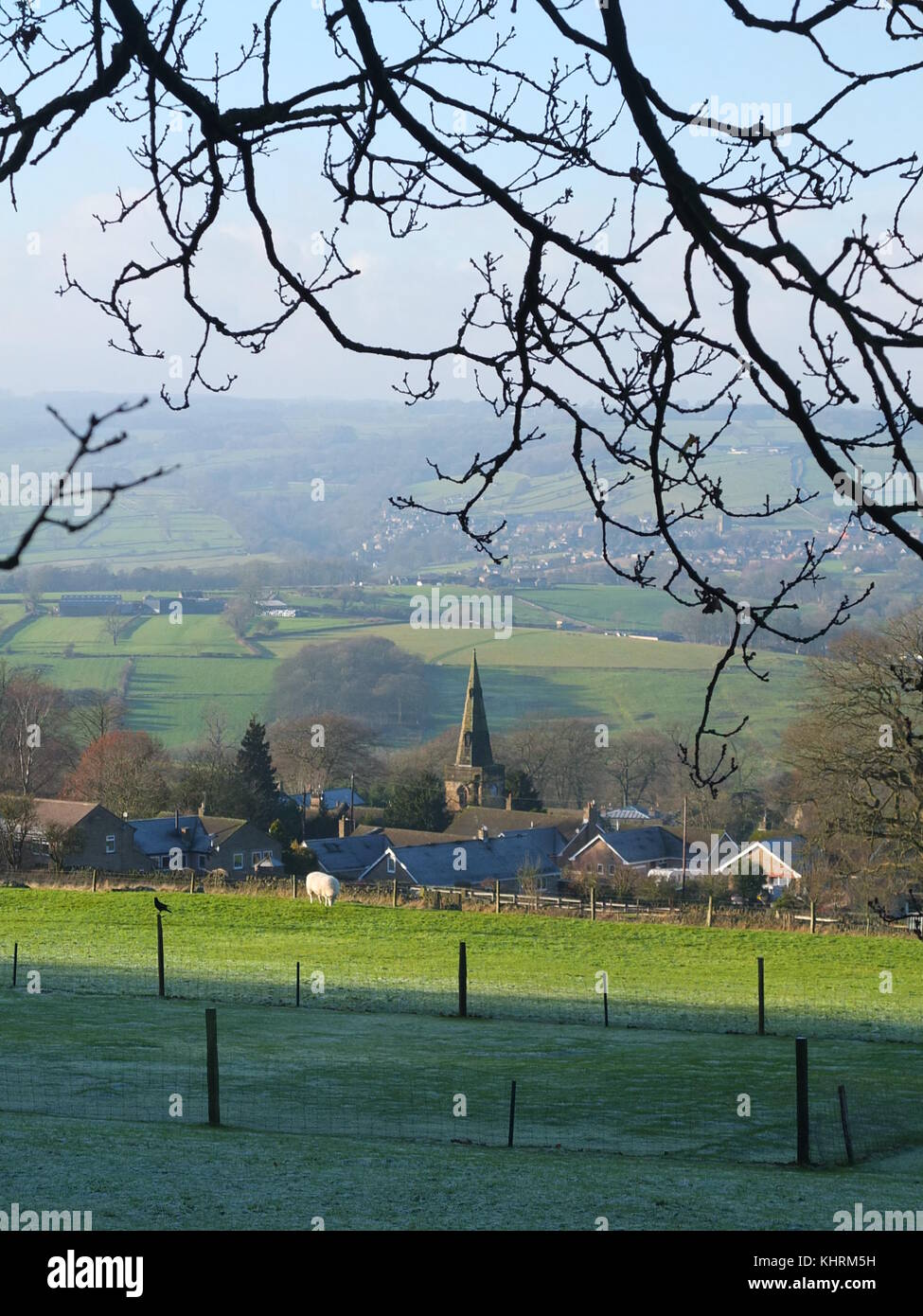 The church and village of Stanton in Peak and surrounding landscape in the Derbyshire Peak District on a frosty winter's day Stock Photo
