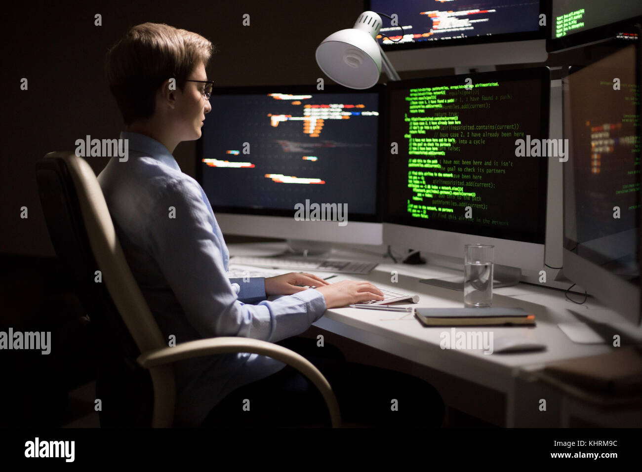 Profile view of confident middle-aged programmer in eyeglasses sitting ...