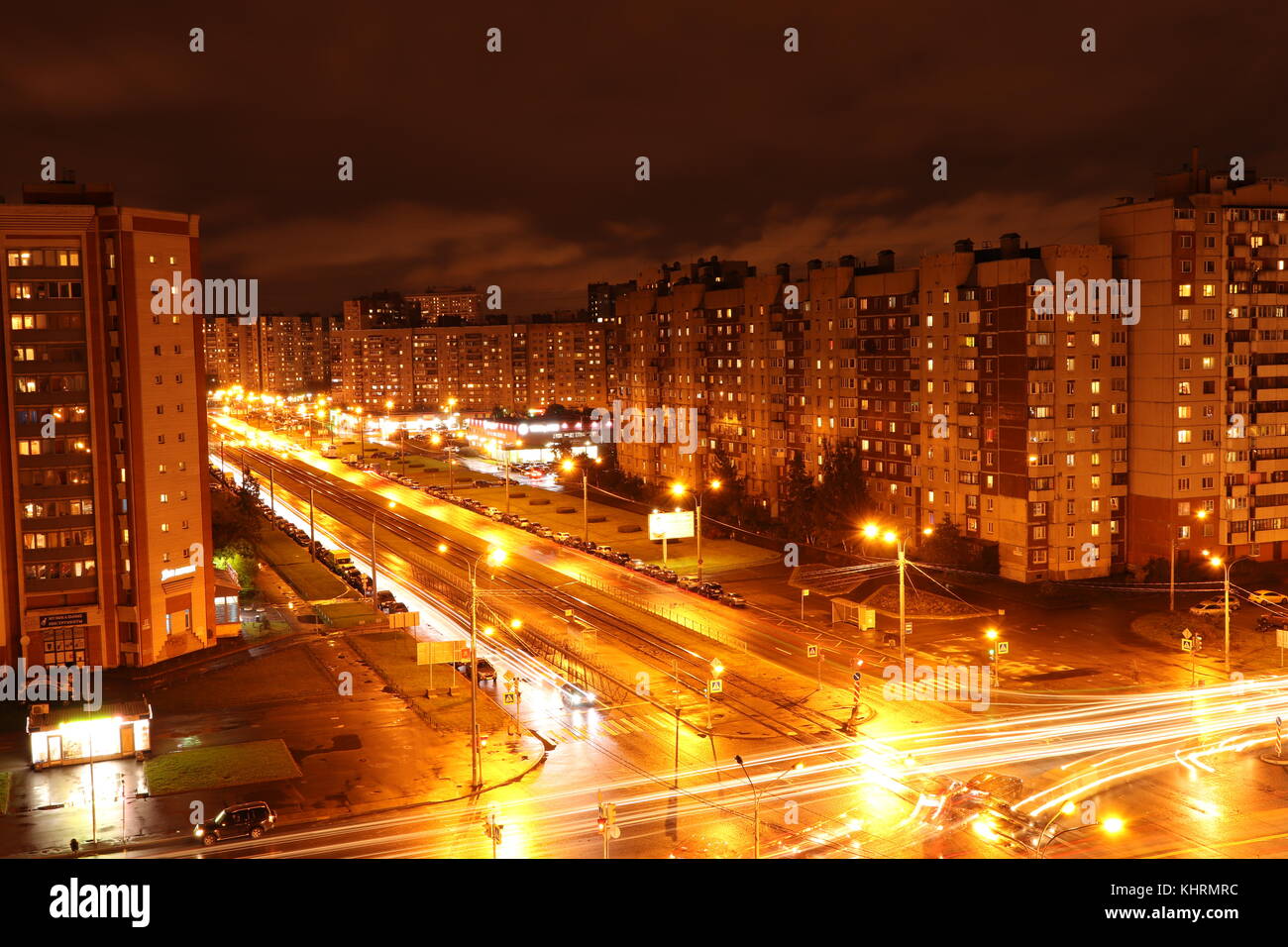 Night crossroad road lights exposure landscape. Living buildings on background. Stock Photo
